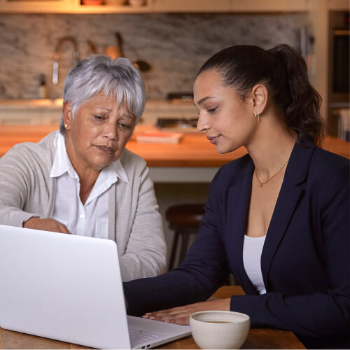Attorney and elderly woman looking at laptop.